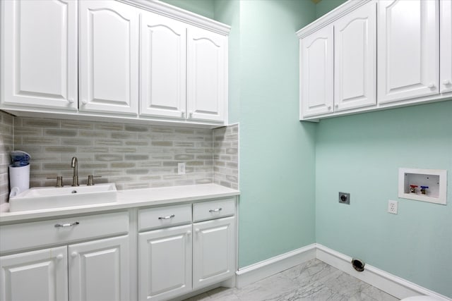 clothes washing area featuring washer hookup, cabinets, sink, and hookup for an electric dryer