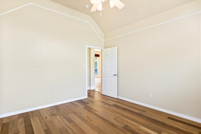 spare room with ceiling fan, hardwood / wood-style flooring, and high vaulted ceiling