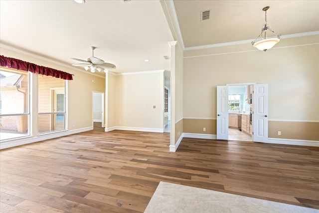 spare room with ceiling fan, ornamental molding, and hardwood / wood-style floors