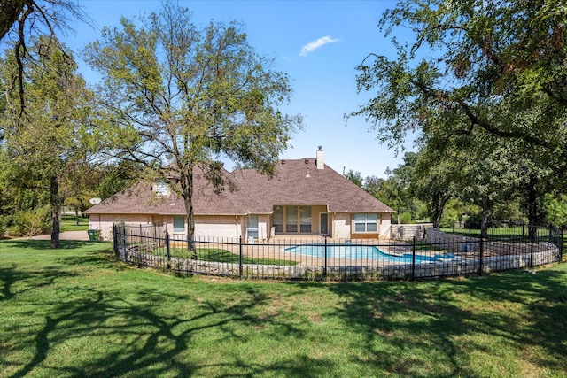 view of pool with a yard