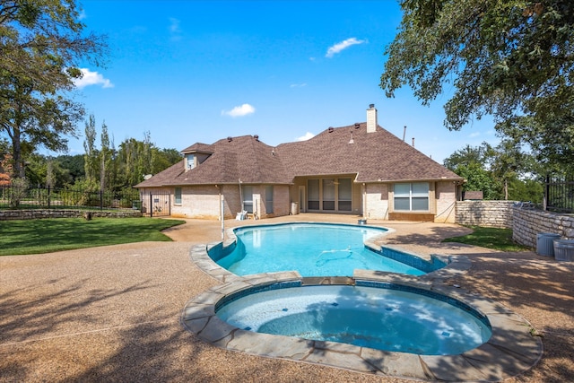 view of swimming pool with an in ground hot tub and a patio area