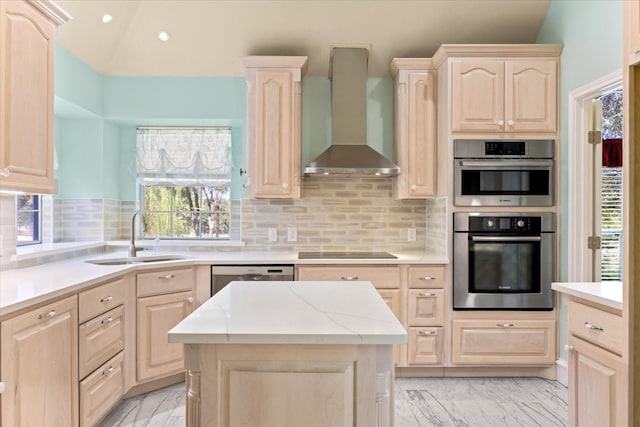 kitchen with wall chimney range hood, light brown cabinetry, a sink, marble finish floor, and stainless steel appliances
