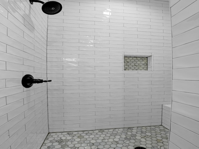 bathroom with a tile shower