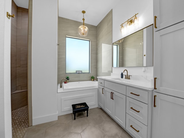 bathroom featuring shower with separate bathtub, tile patterned flooring, and vanity