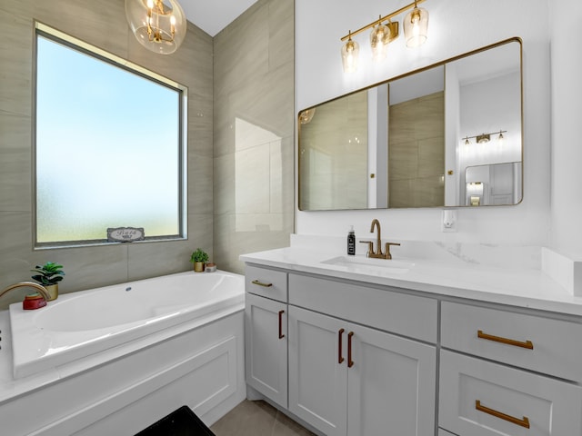 bathroom featuring vanity, a tub to relax in, and tile walls