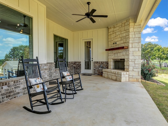 view of patio / terrace featuring an outdoor stone fireplace and ceiling fan