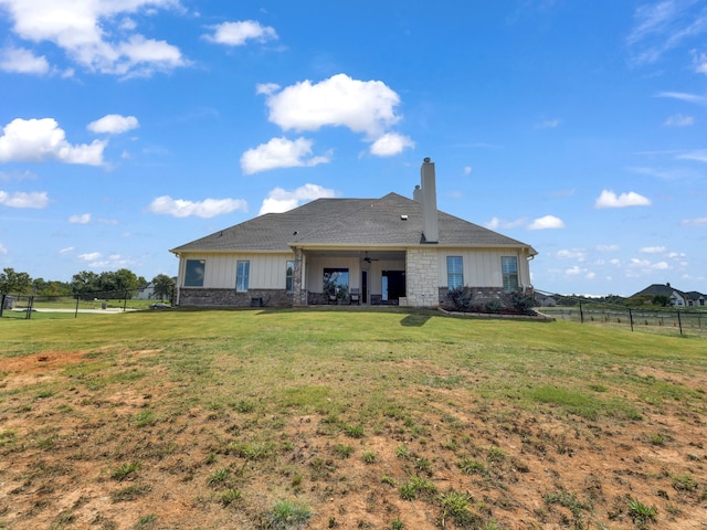 back of property featuring a lawn