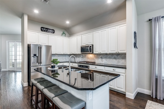 kitchen featuring white cabinets, a kitchen island with sink, and stainless steel appliances