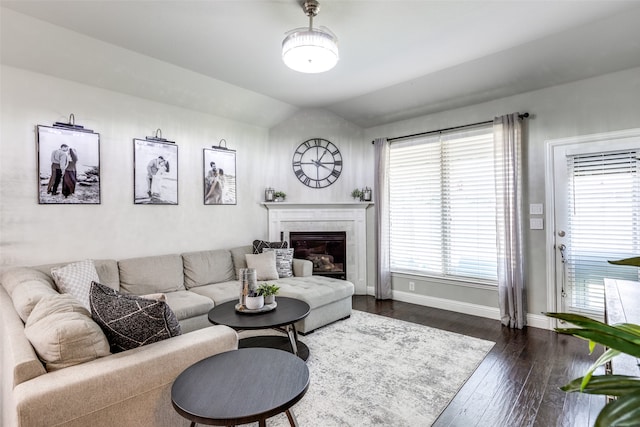 living room with dark wood-type flooring and vaulted ceiling