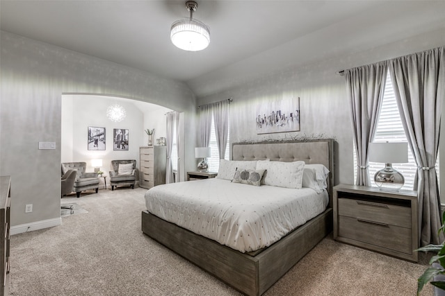 bedroom with light carpet and vaulted ceiling