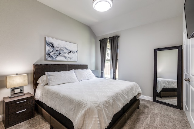 carpeted bedroom with lofted ceiling