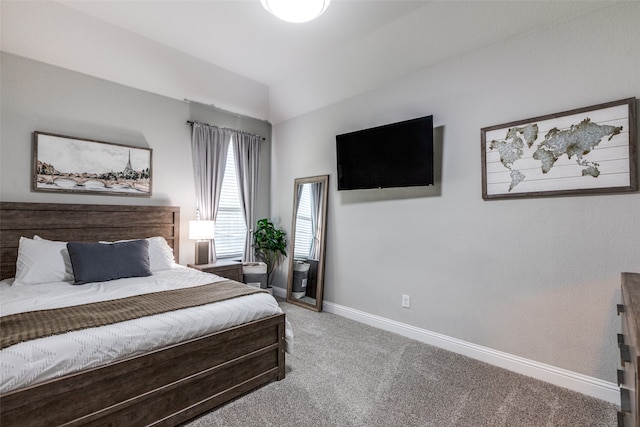 carpeted bedroom featuring lofted ceiling