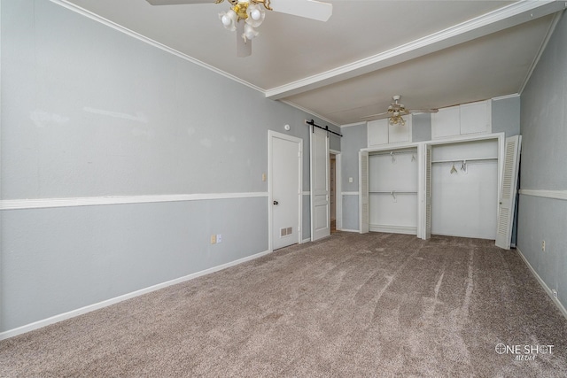 interior space featuring ceiling fan, carpet floors, crown molding, and a barn door