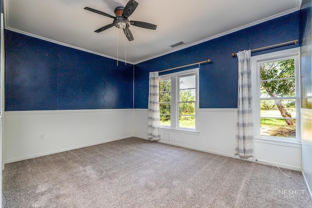 carpeted empty room featuring ceiling fan and ornamental molding