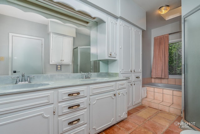 bathroom featuring vanity and separate shower and tub