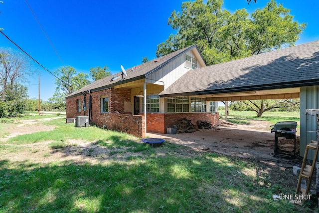 view of side of home with a carport and central AC