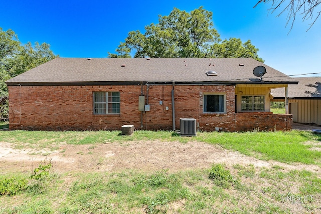 rear view of property featuring central air condition unit