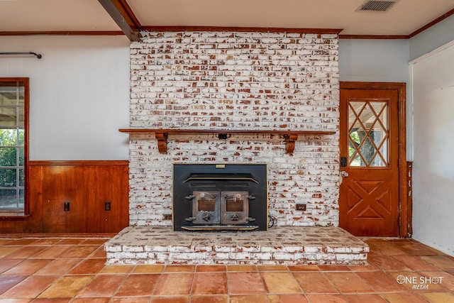 room details with a brick fireplace, wood walls, and ornamental molding