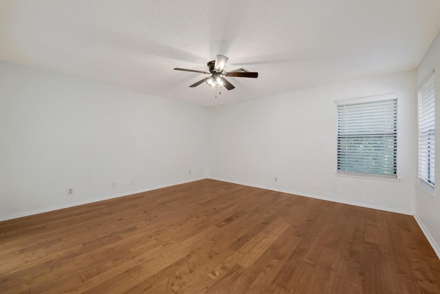 unfurnished room featuring ceiling fan, a textured ceiling, and wood-type flooring