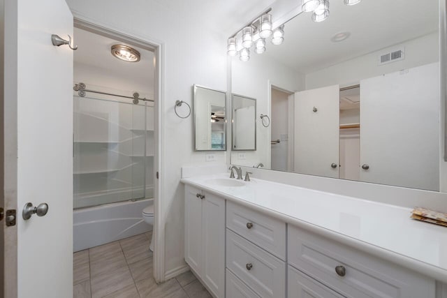 full bathroom featuring bath / shower combo with glass door, toilet, vanity, and tile patterned floors