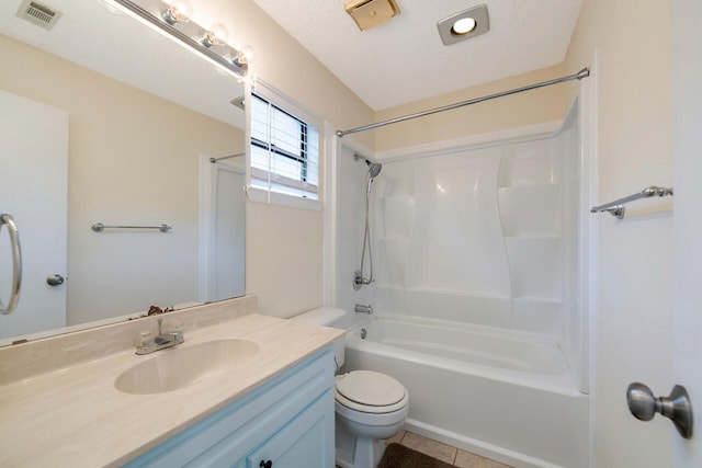 full bathroom with vanity, shower / bath combination, a textured ceiling, tile patterned floors, and toilet