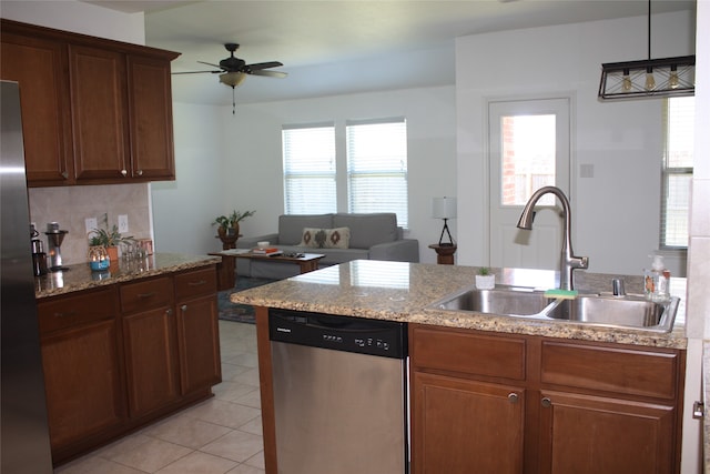 kitchen with appliances with stainless steel finishes, light tile patterned floors, ceiling fan, decorative light fixtures, and sink