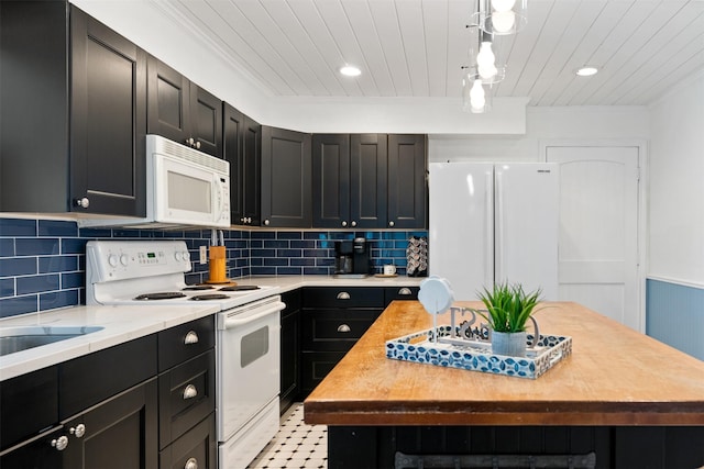 kitchen featuring wood ceiling, dark cabinetry, backsplash, and white appliances
