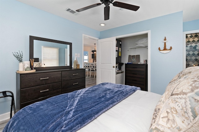 bedroom with baseboards, visible vents, and a ceiling fan