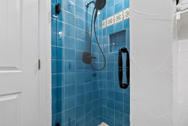 bathroom with tiled shower