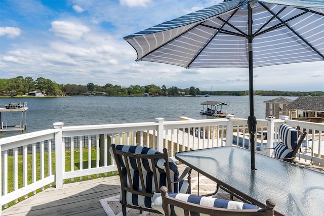 wooden deck featuring a water view and a boat dock