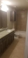 bathroom with vanity, tile patterned flooring, and toilet