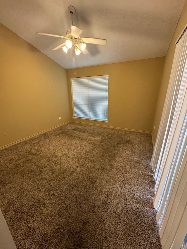 carpeted spare room with a textured ceiling and ceiling fan