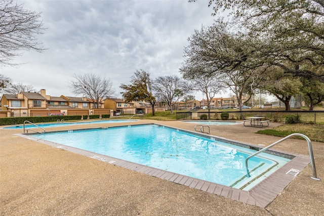 view of swimming pool with a patio