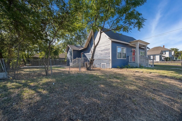 view of side of home featuring a lawn