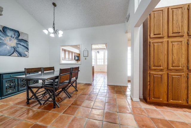 tiled dining room with an inviting chandelier, vaulted ceiling, and a textured ceiling