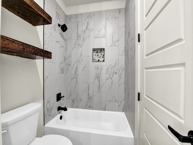 bathroom featuring tiled shower / bath and toilet