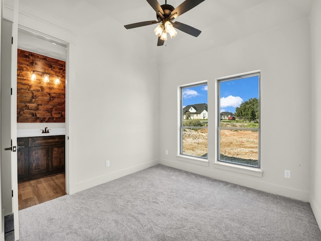 unfurnished bedroom featuring ceiling fan and carpet flooring