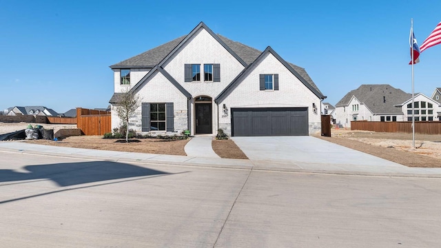 view of front of house with a garage, brick siding, fence, concrete driveway, and roof with shingles