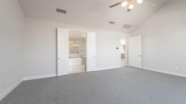 unfurnished bedroom with vaulted ceiling, carpet floors, visible vents, and baseboards