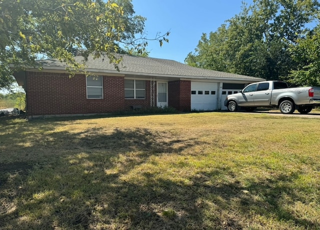 single story home featuring a garage and a front yard