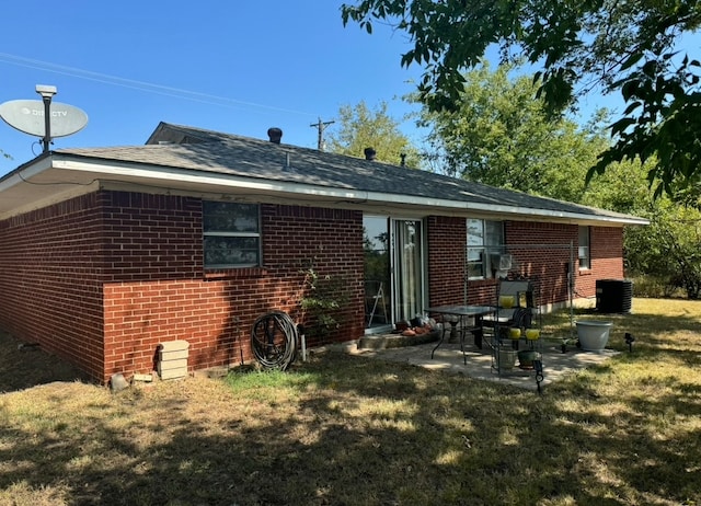 back of house with a yard and a patio