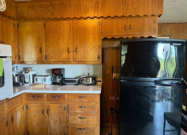 kitchen with white oven and black refrigerator