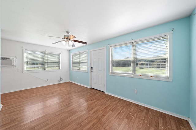 unfurnished room featuring hardwood / wood-style floors, a wealth of natural light, and ceiling fan