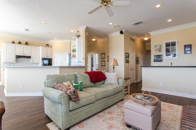 living room featuring ornamental molding, wood-type flooring, and ceiling fan