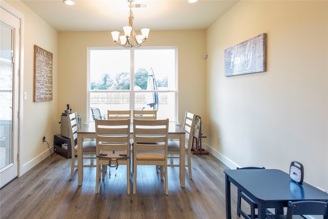 dining room with a notable chandelier and hardwood / wood-style floors