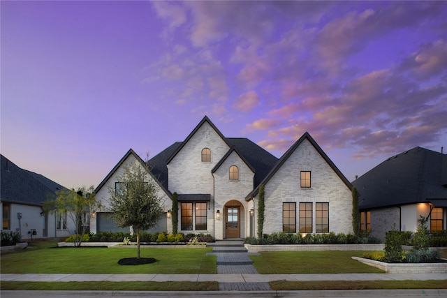 french country style house with a yard