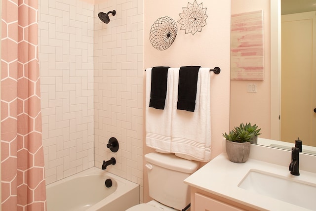 full bathroom with vanity, toilet, and tiled shower / bath