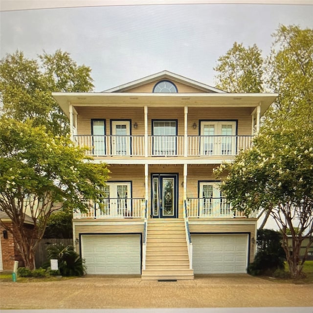 view of front of house with a balcony, covered porch, and a garage