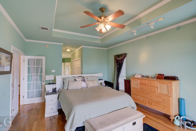 bedroom featuring ornamental molding, wood-type flooring, and ceiling fan