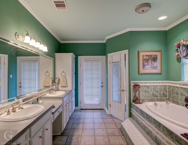 bathroom featuring vanity, tiled bath, ornamental molding, and tile patterned floors